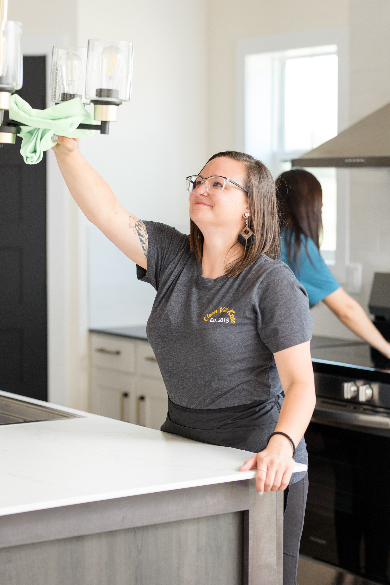 Two Clean Vibz Kzoo technicians cleaning a kitchen together